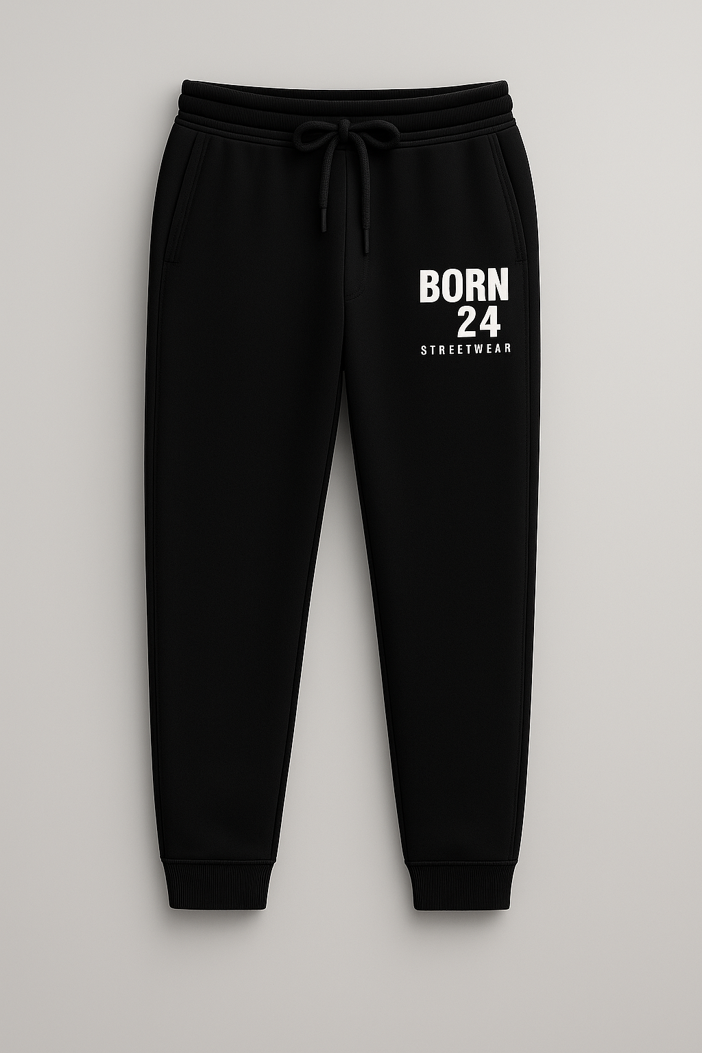 Black sweatpants with 'BORN 24 STREETWEAR' text on a light gray background