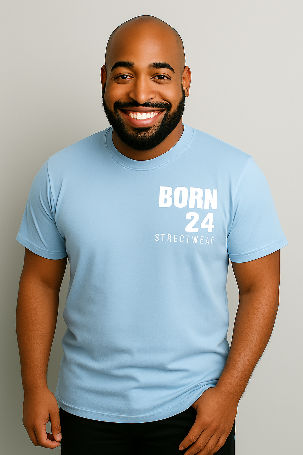 Man wearing a light blue t-shirt with 'BORN 24 STREETWEAR' text on a plain background