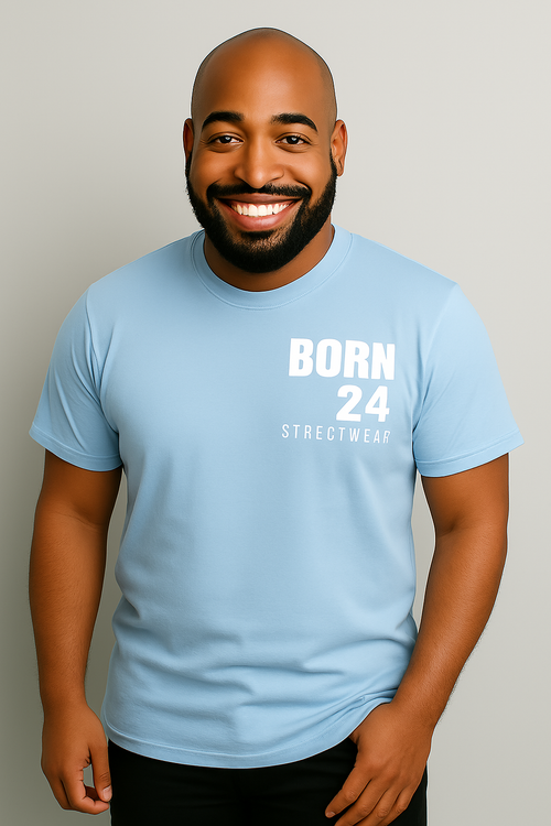 Man wearing a light blue t-shirt with 'BORN 24 STREETWEAR' text on a plain background