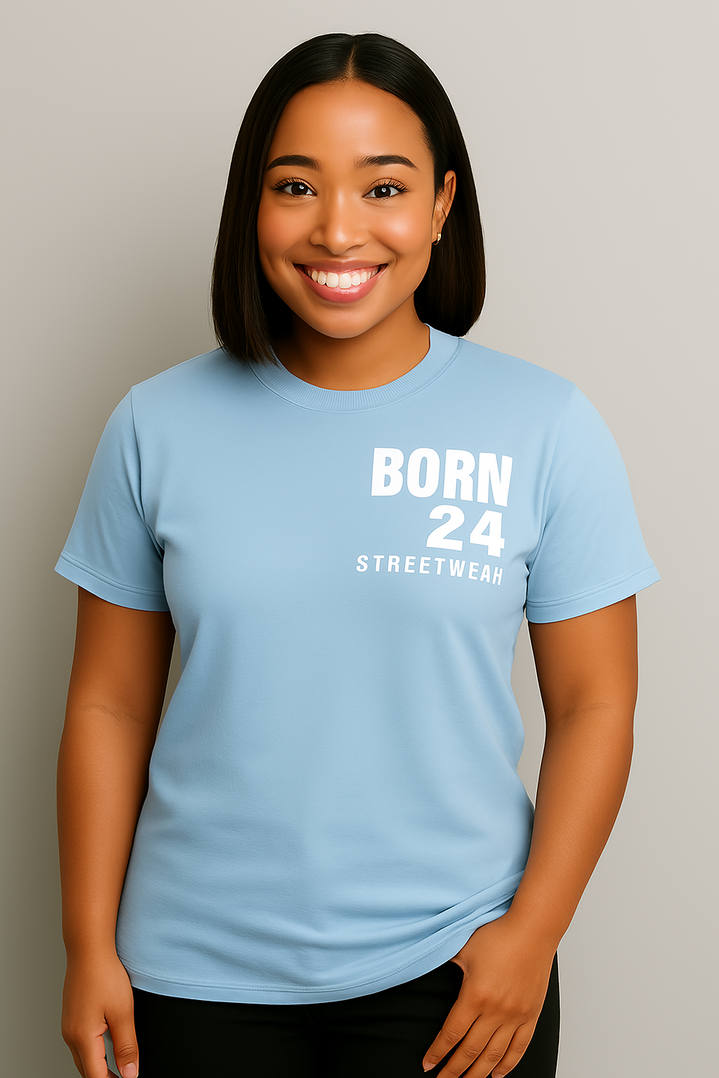 Person wearing a light blue t-shirt with 'BORN 24 STREETWEAR' text on a plain background